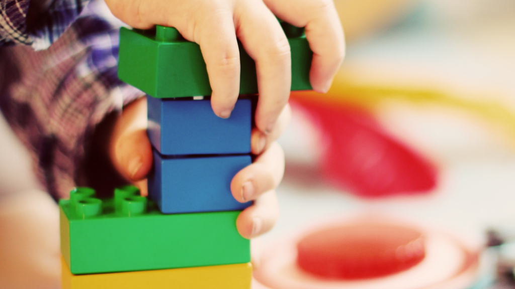 Image of a child's hands with building blocks