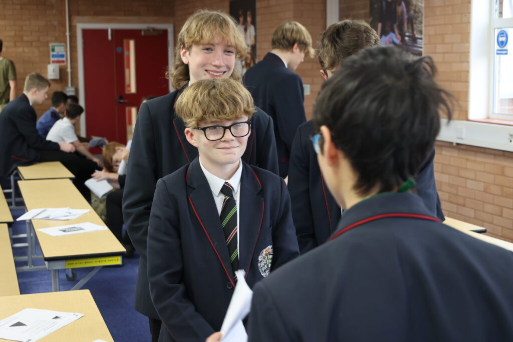 Three boys in school uniform in a classroom