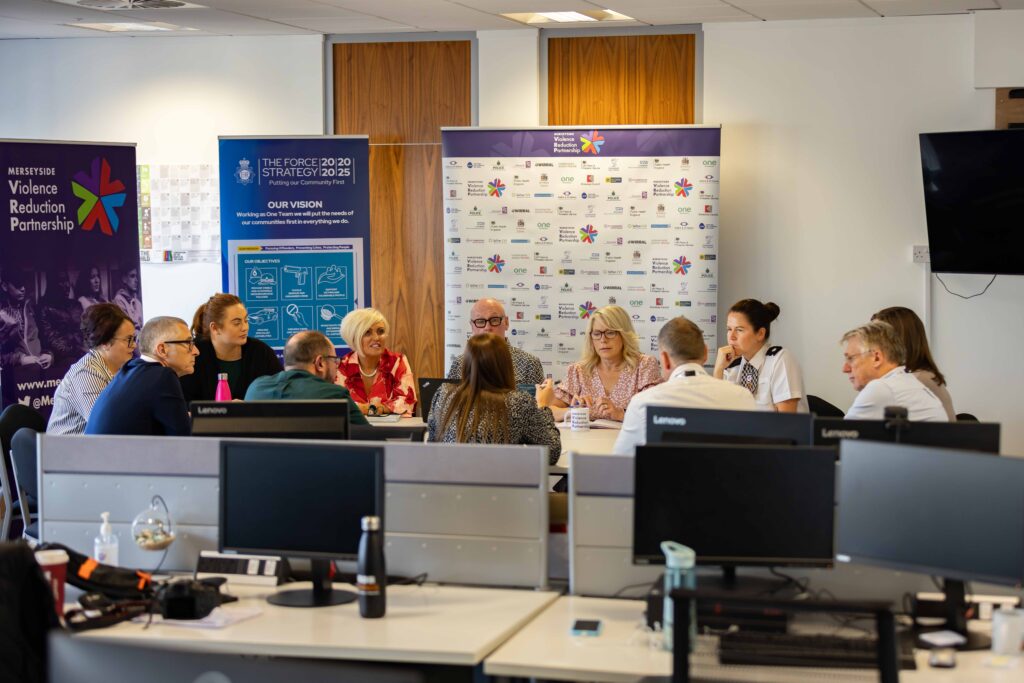 Photograph of out team in the office round a board table