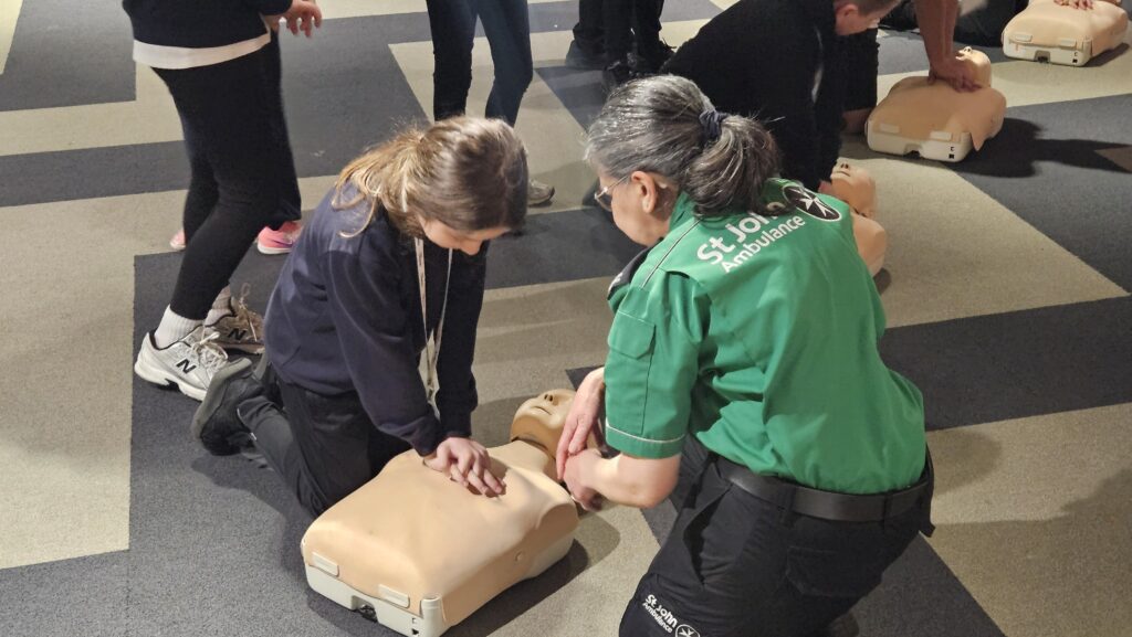 A young girl learning first aid