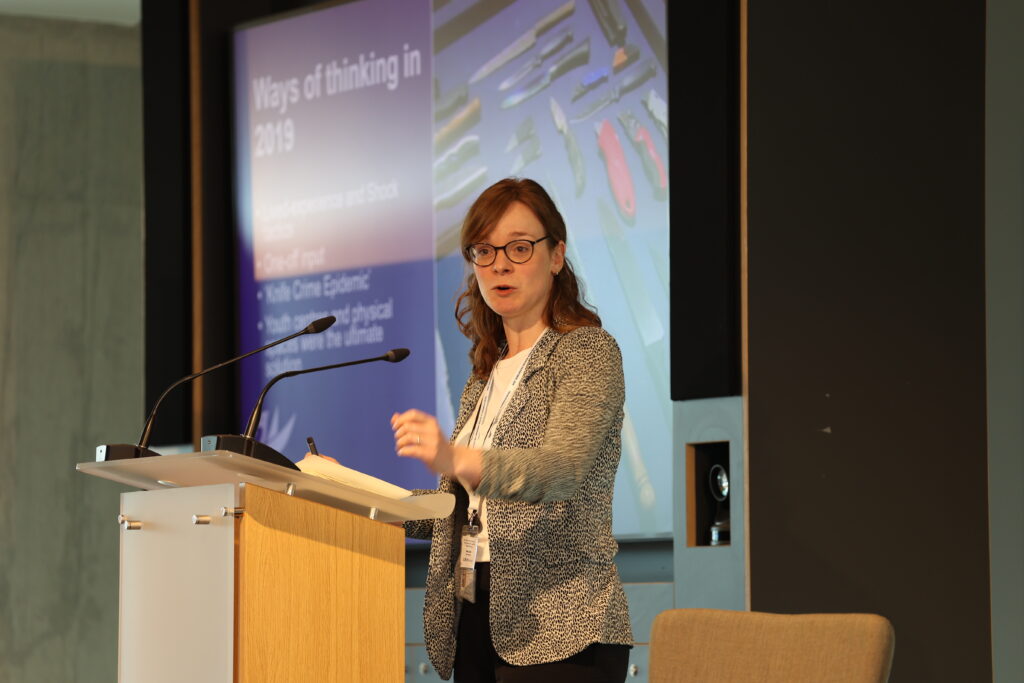 Woman presenting at the Evidence to Action conference