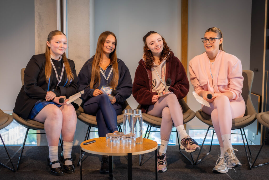 Young women presenting at the Evidence to Action conference